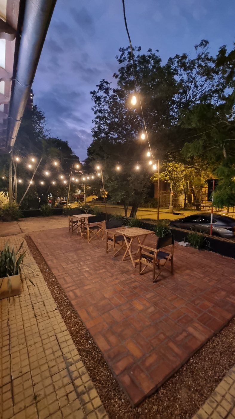 Terrasse mit Ziegelpflaster und Lichterkette am Abend